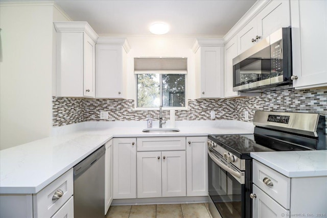 kitchen featuring sink, white cabinets, and appliances with stainless steel finishes