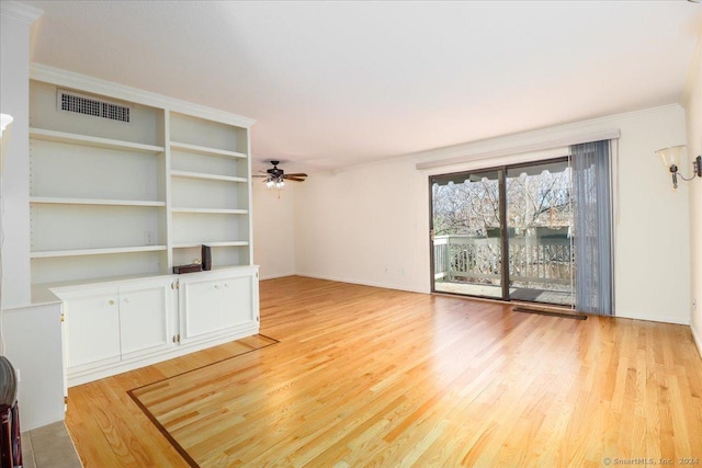 unfurnished living room featuring ornamental molding, ceiling fan, and light wood-type flooring