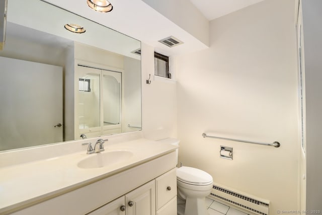 bathroom featuring baseboard heating, tile patterned floors, vanity, and toilet