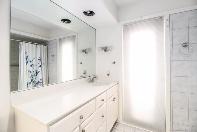 bathroom featuring walk in shower, tile patterned floors, and vanity