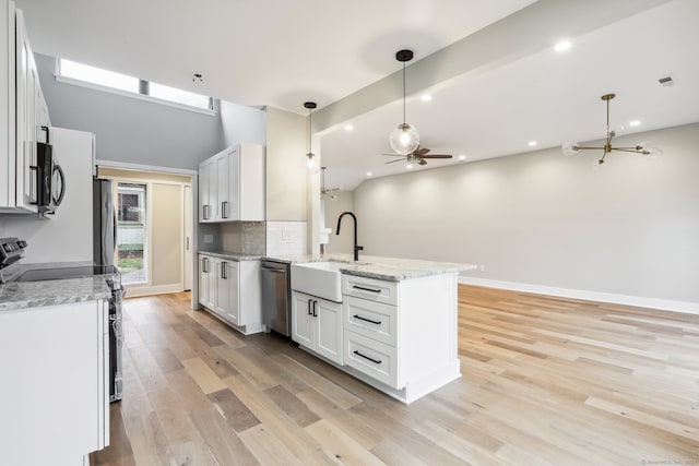 kitchen featuring white cabinets, pendant lighting, sink, and appliances with stainless steel finishes