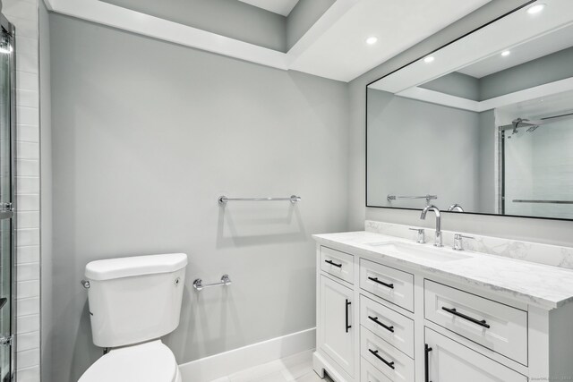 bathroom featuring tile patterned floors, vanity, and toilet