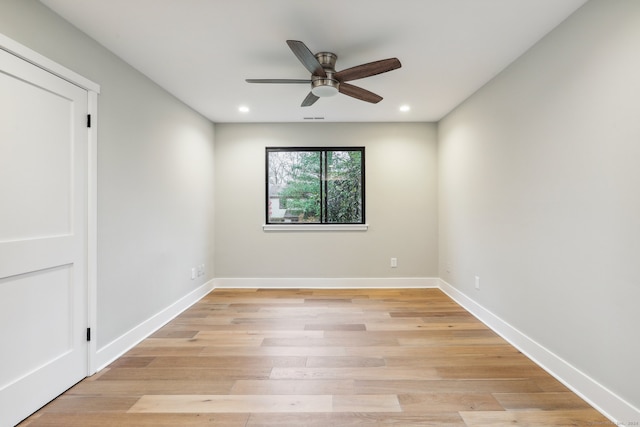 spare room featuring light hardwood / wood-style flooring and ceiling fan