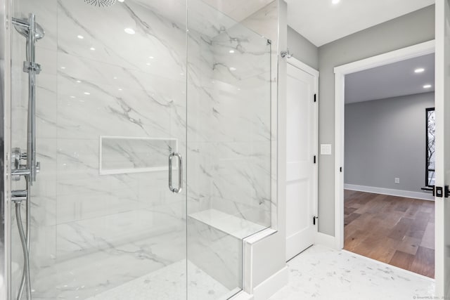 bathroom featuring an enclosed shower and wood-type flooring