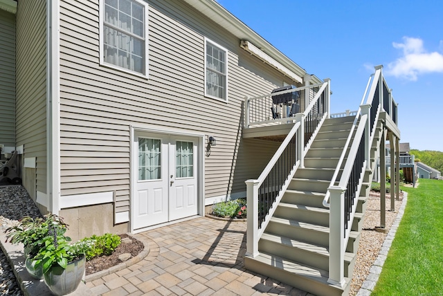 back of house with stairs, a wooden deck, and french doors