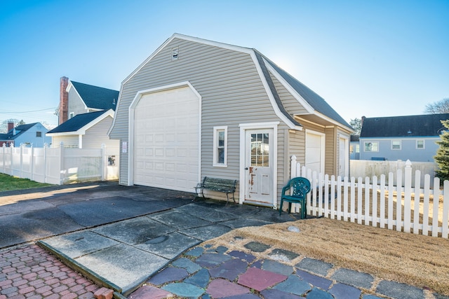 exterior space with an outbuilding and a garage