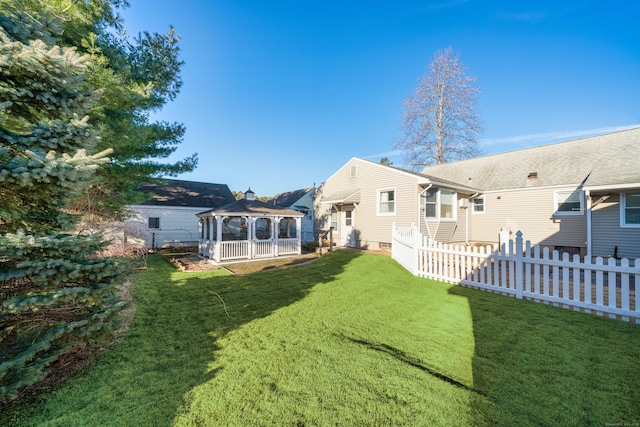 back of house with a gazebo and a lawn