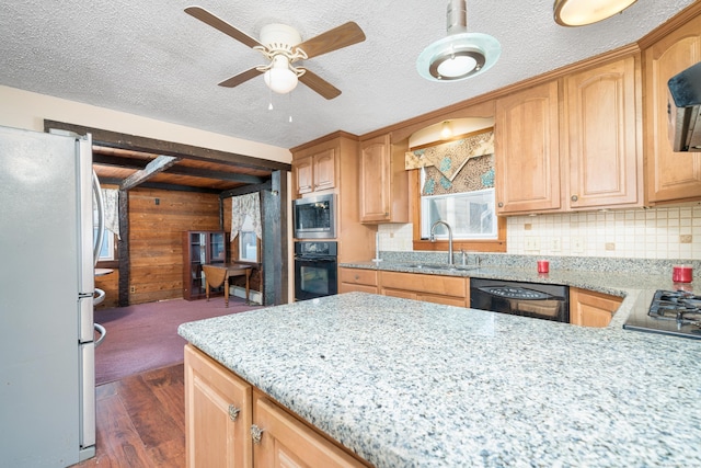 kitchen with black appliances, sink, ceiling fan, dark hardwood / wood-style floors, and light stone countertops