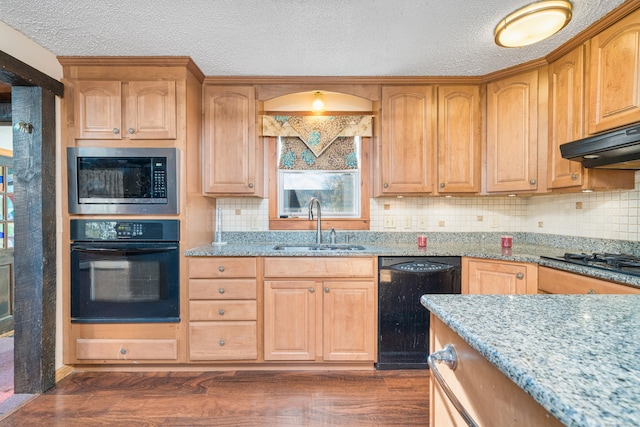 kitchen featuring sink, exhaust hood, light stone counters, dark hardwood / wood-style flooring, and black appliances