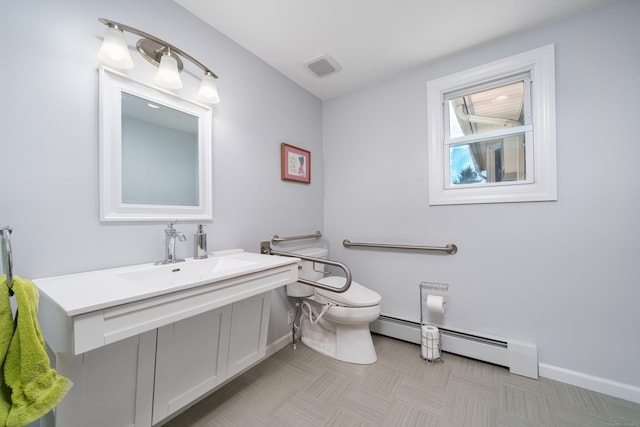 bathroom featuring a baseboard radiator, toilet, and sink