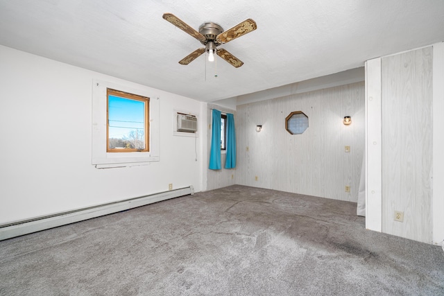 empty room featuring carpet, ceiling fan, baseboard heating, and a wall mounted AC