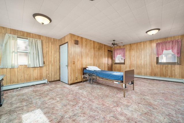 bedroom featuring carpet flooring, wooden walls, and a baseboard radiator