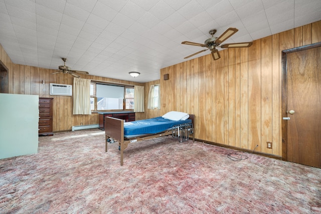 bedroom with a wall mounted AC, ceiling fan, wooden walls, and a baseboard heating unit