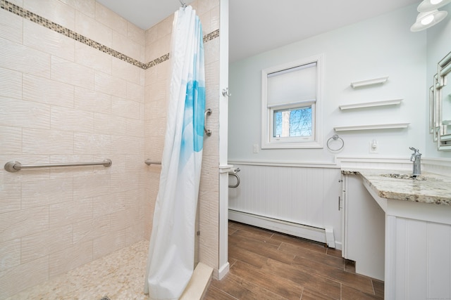 bathroom with sink, walk in shower, and a baseboard radiator