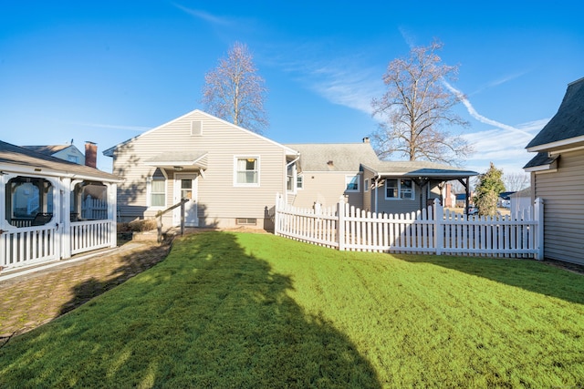 rear view of property with a lawn