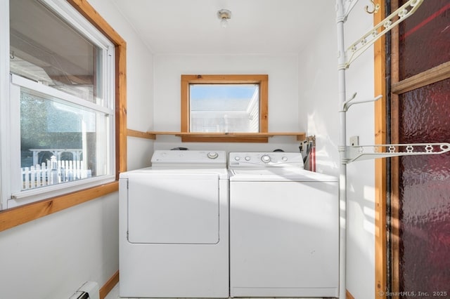 washroom with washer and clothes dryer and a baseboard heating unit