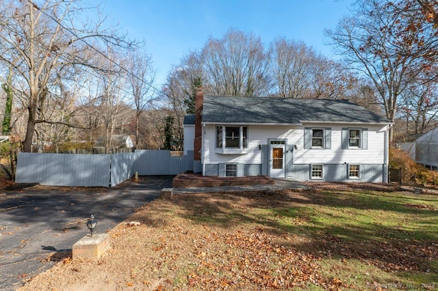 split foyer home with a front lawn