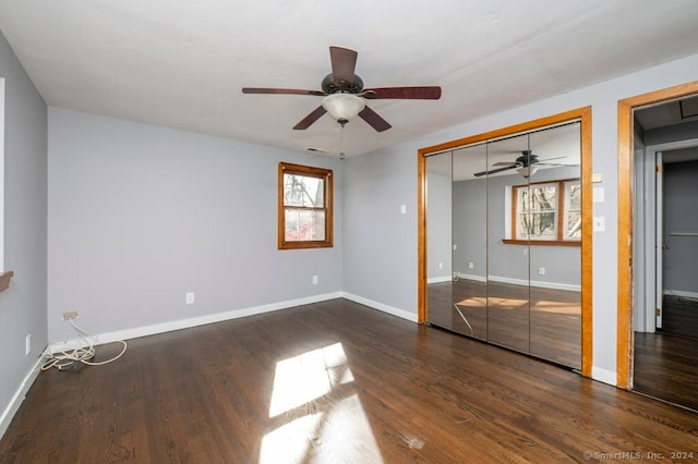 unfurnished bedroom featuring a closet, dark hardwood / wood-style floors, and ceiling fan