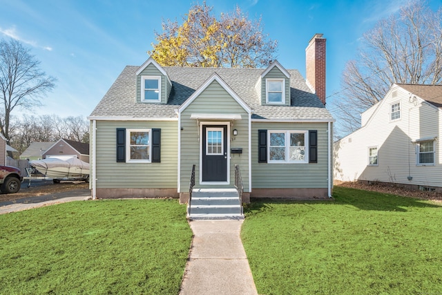 cape cod house featuring a front yard