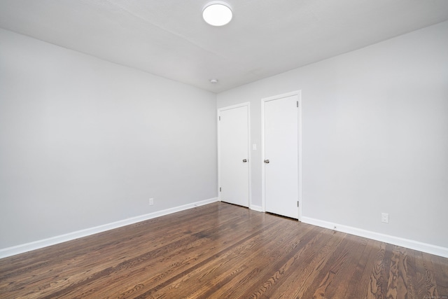 spare room with dark hardwood / wood-style flooring