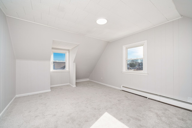 bonus room featuring light colored carpet, vaulted ceiling, and baseboard heating