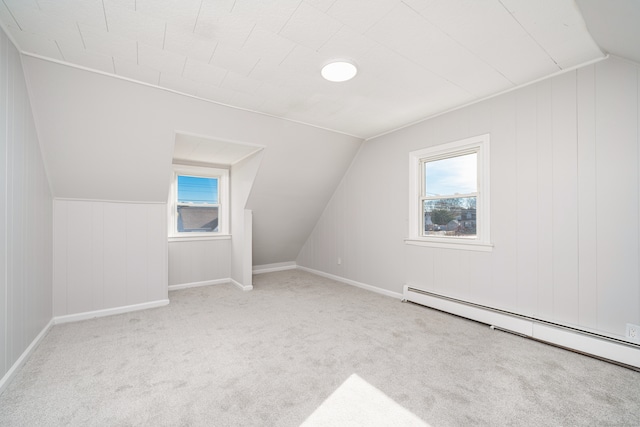 bonus room featuring vaulted ceiling, light colored carpet, and a baseboard radiator