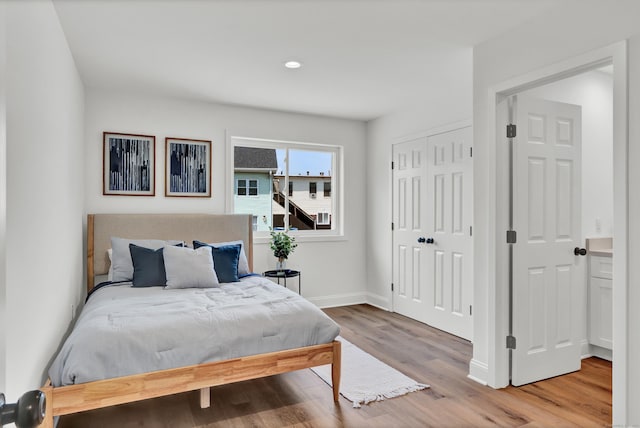 bedroom with a closet and light wood-type flooring