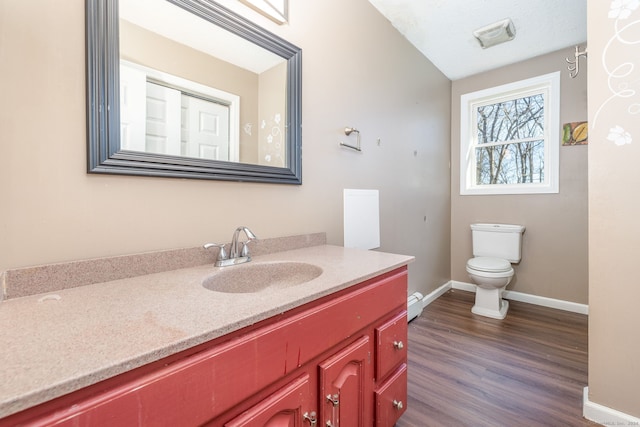 bathroom featuring hardwood / wood-style floors, vanity, and toilet