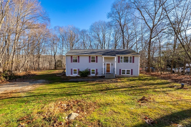 raised ranch with a front yard