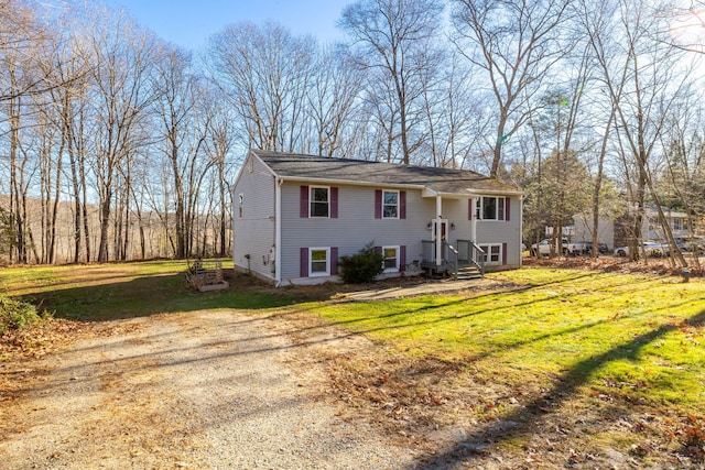 raised ranch with a front yard