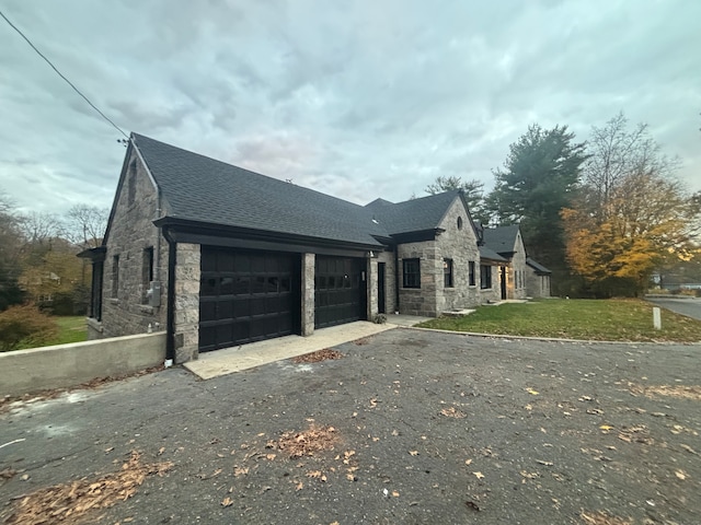 view of front of home featuring a garage and a front lawn