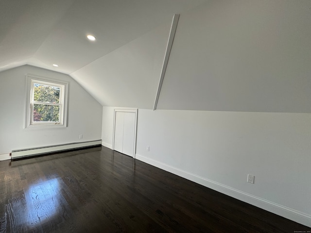 bonus room featuring dark hardwood / wood-style floors, baseboard heating, and lofted ceiling