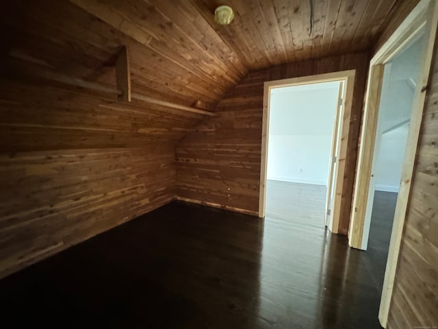 bonus room featuring wood walls, dark wood-type flooring, wooden ceiling, and lofted ceiling