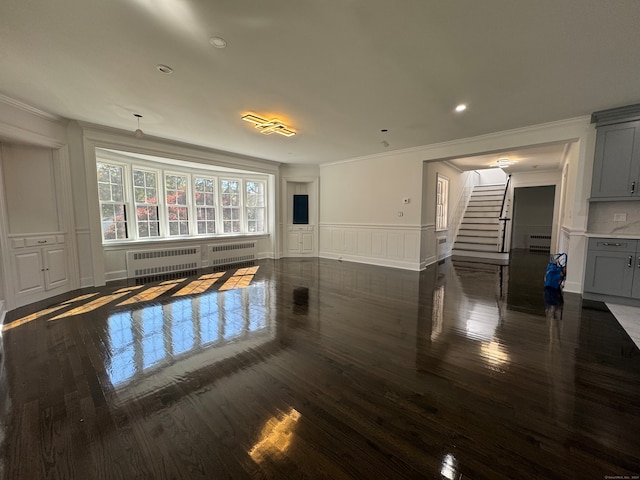 living room with dark hardwood / wood-style floors, crown molding, and radiator