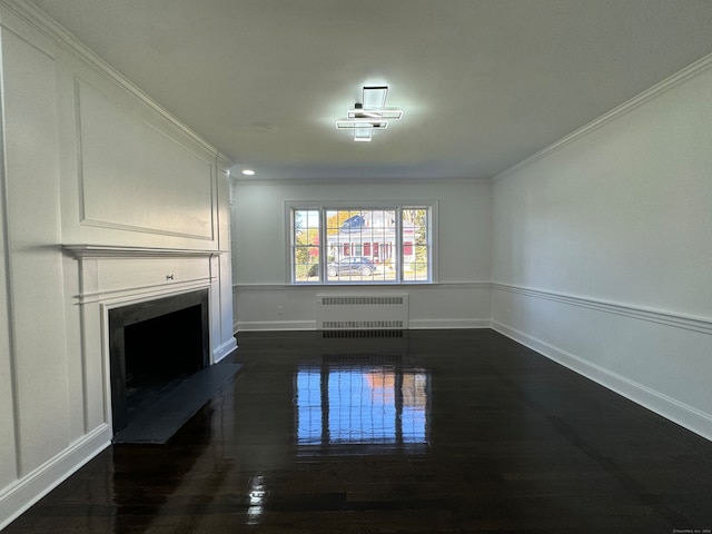 unfurnished living room with crown molding, radiator heating unit, and dark hardwood / wood-style floors