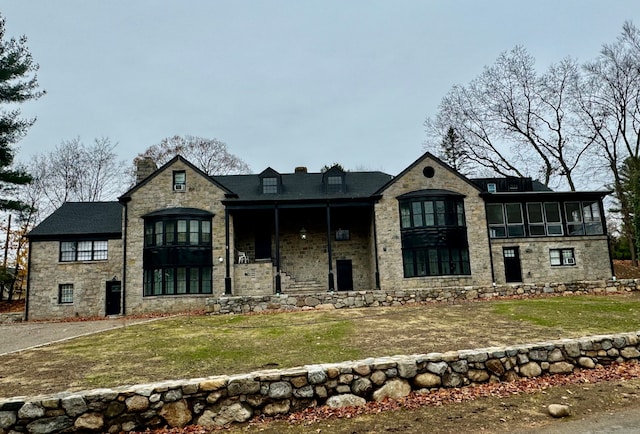 french country style house featuring a front yard