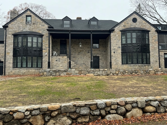 french country style house featuring a front lawn