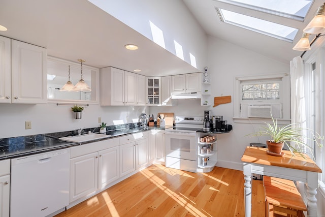 kitchen with hanging light fixtures, sink, white cabinetry, white appliances, and light hardwood / wood-style floors