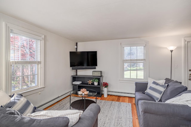 living room with light wood-type flooring and a baseboard radiator