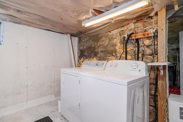 clothes washing area featuring washing machine and clothes dryer