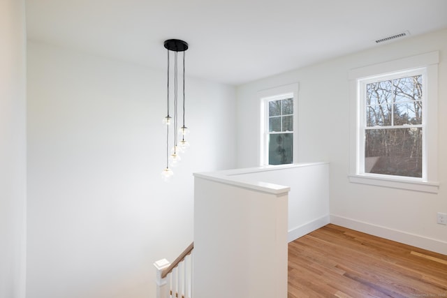 hall with light hardwood / wood-style floors