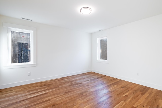 empty room with light hardwood / wood-style flooring