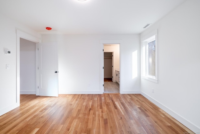 empty room with light hardwood / wood-style flooring