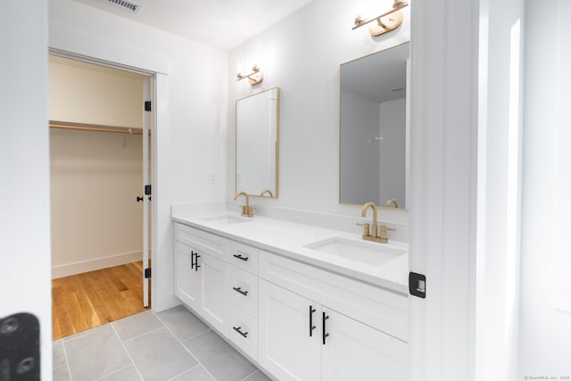 bathroom with tile patterned floors and vanity