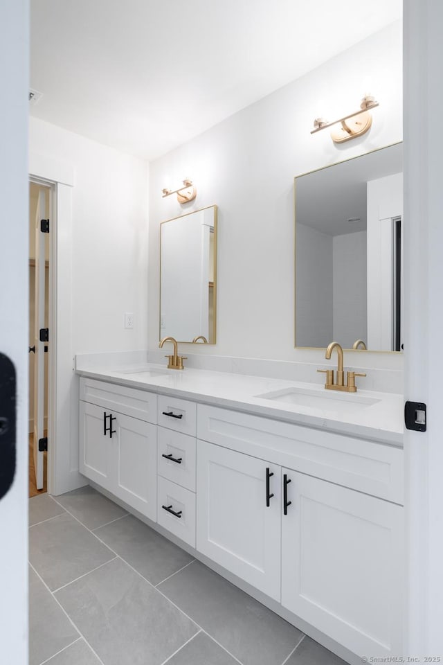 bathroom with tile patterned floors and vanity