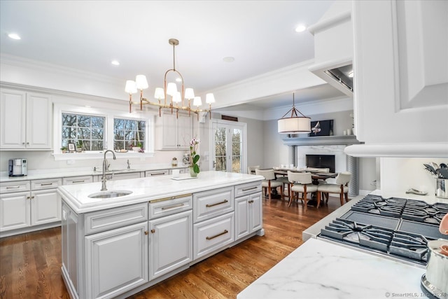 kitchen featuring white cabinets, a center island, decorative light fixtures, and dark hardwood / wood-style floors