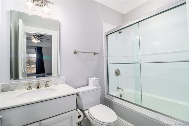 full bathroom featuring vanity, ceiling fan, toilet, enclosed tub / shower combo, and ornamental molding