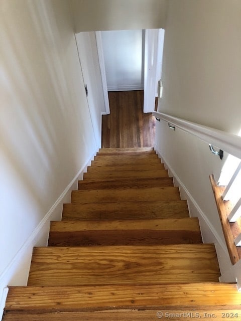 stairway with wood-type flooring