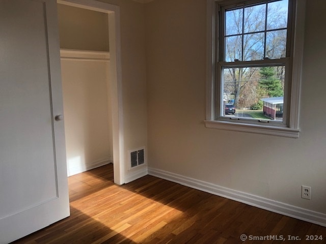 unfurnished bedroom featuring a closet and wood-type flooring