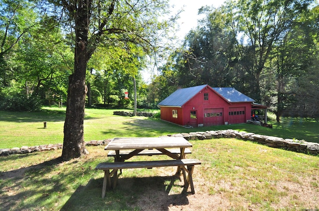 view of yard featuring a garage and an outdoor structure